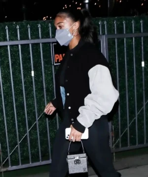 Black and white varsity jacket inspired by Lori Harvey with sleek silhouette, high-quality craftsmanship, and contemporary urban fashion appeal