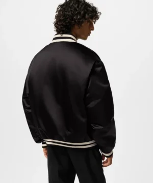 Black satin bomber jacket by Louis Vuitton with sleek silhouette, premium fabric, and high-end fashion aesthetics