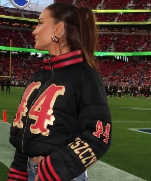 Celebrity-style Kristin Juszczyk black puffer jacket showcasing sleek silhouette and statement NFL fashion look