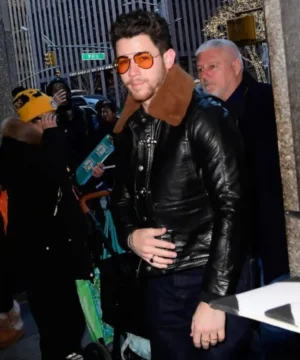 Celebrity-style Nick Jonas black leather jacket showcasing refined silhouette and contemporary studio look